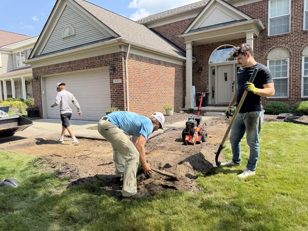 Total 1 crew preparing soil beside an existing residential lawn